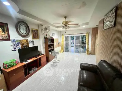 Spacious living room with modern decor and large windows for natural light.