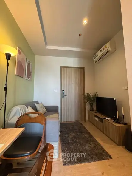 Cozy living room with modern decor, featuring a comfortable sofa, TV unit, and stylish lighting.