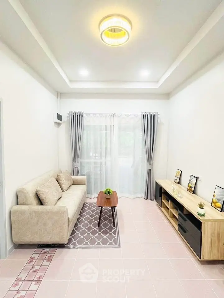 Modern living room with cozy sofa, stylish decor, and natural light through large windows.