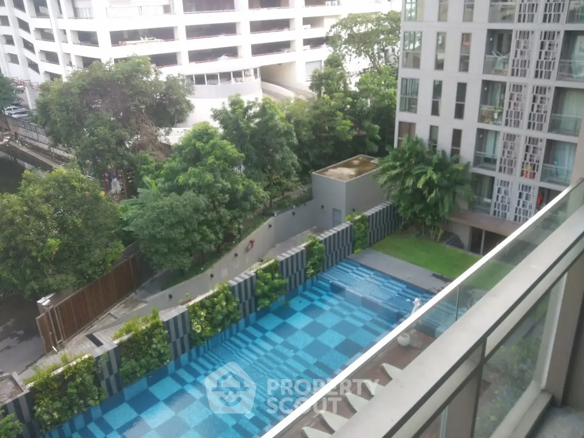 Luxurious apartment with stunning pool view and lush greenery