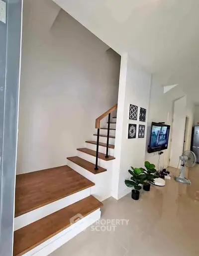 Modern interior with wooden staircase and stylish decor