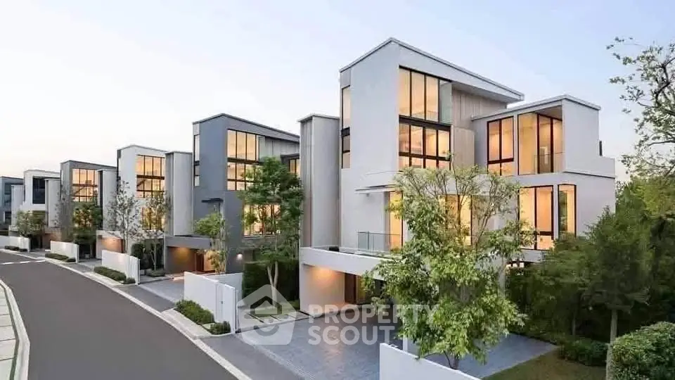 Modern luxury townhouses with sleek design and large windows in a serene neighborhood.