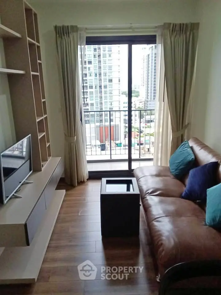 Cozy living room with leather sofa and city view balcony in modern apartment