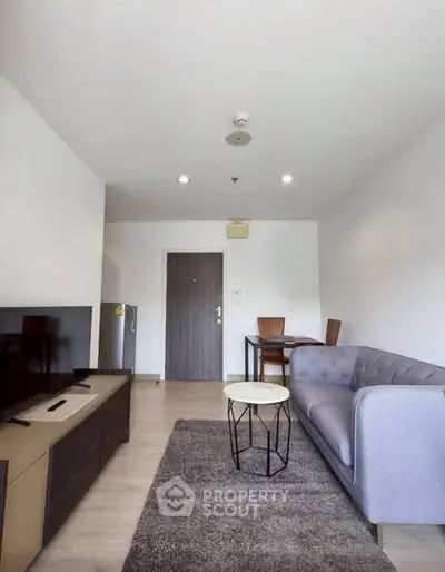 Modern living room with stylish furniture and natural light, perfect for relaxation and entertainment.