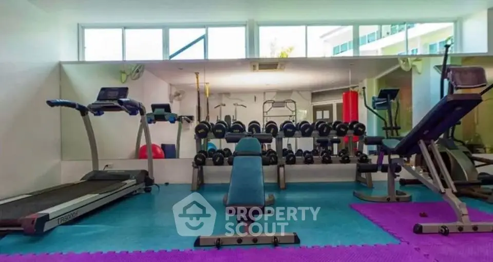 Modern gym with state-of-the-art equipment in luxury residential building.