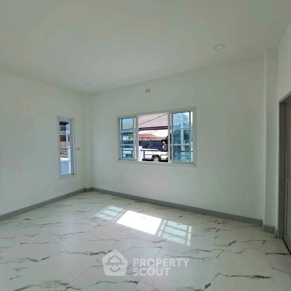 Spacious unfurnished room with large windows and marble flooring, perfect for customization.
