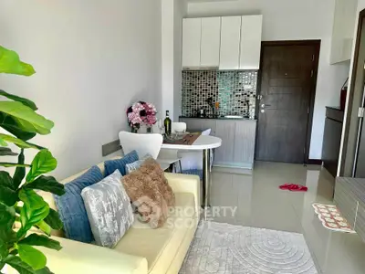 Chic modern living room with cozy sofa and stylish kitchen in open layout apartment.