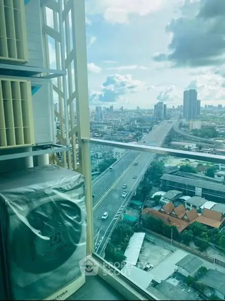 Stunning cityscape view from high-rise balcony with modern air conditioning unit.