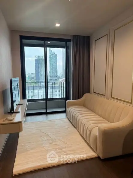 Modern living room with city view, elegant sofa, and large window balcony access.