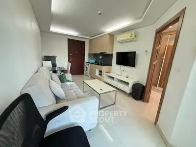 Modern living room with sleek furniture and integrated kitchen appliances