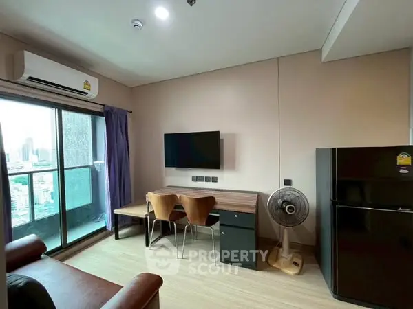 Modern living room with balcony view, air conditioning, and sleek furniture.