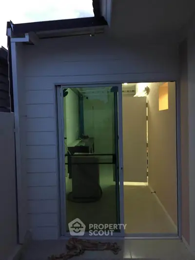 Modern exterior with sliding glass door leading to interior space