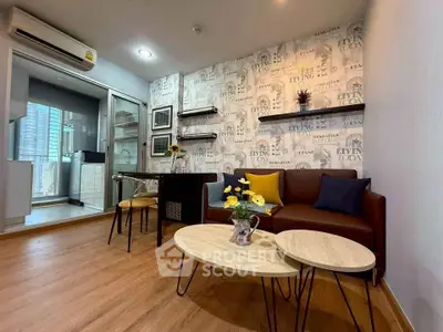 Modern living room with stylish decor and open kitchen layout in a cozy apartment.
