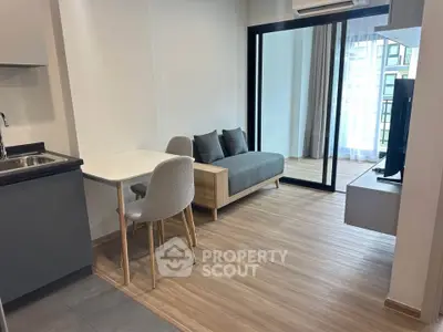 Modern apartment interior with open layout, featuring a cozy living area and stylish kitchen.