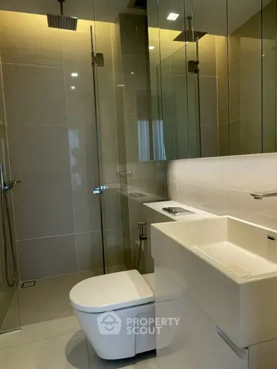 Modern bathroom with sleek fixtures and glass shower enclosure