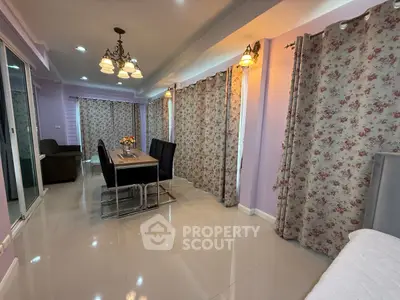 Spacious living room with elegant dining area and floral curtains