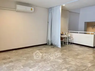 Spacious room with marble flooring and air conditioning, ideal for versatile living space.