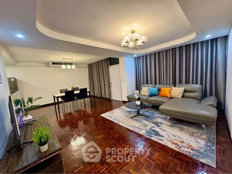 Spacious living room with modern decor and elegant lighting