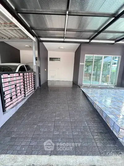 Modern covered parking area with sleek design and tiled flooring