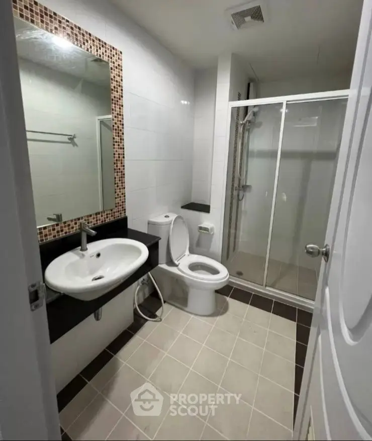 Modern bathroom with glass shower and stylish tile accents