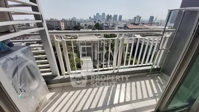 Spacious balcony with city skyline view, perfect for relaxation and enjoying urban living.