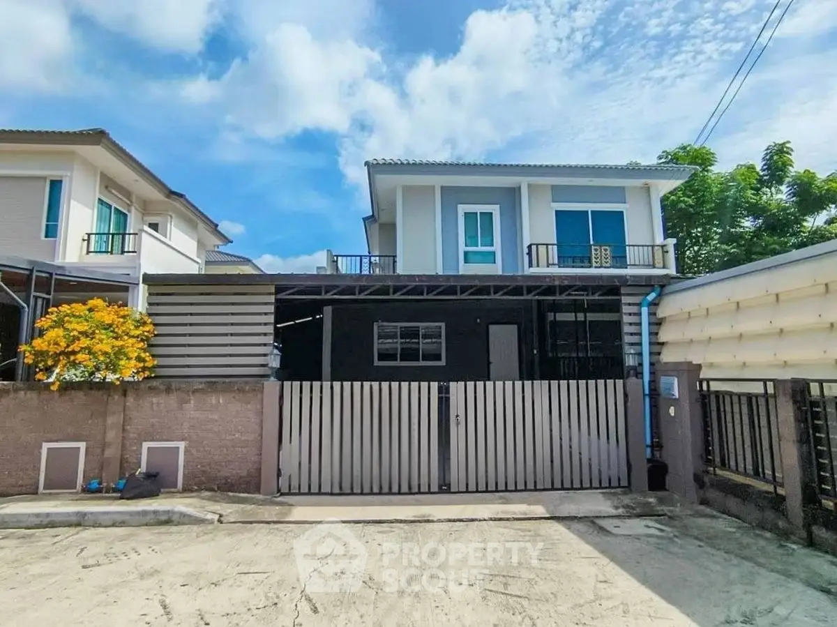 Modern two-story house with gated entrance and spacious driveway