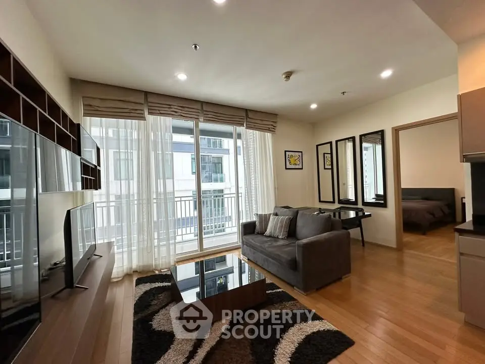Modern living room with cozy sofa, stylish decor, and balcony view in a contemporary apartment.
