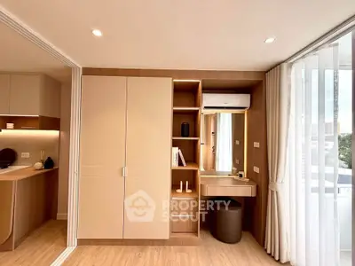 Modern bedroom with built-in wardrobe and vanity in a bright apartment