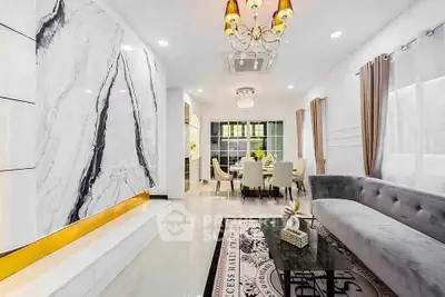 Luxurious modern living room with elegant marble accents and stylish furnishings.