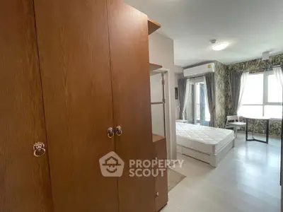 Spacious bedroom with modern decor and ample natural light