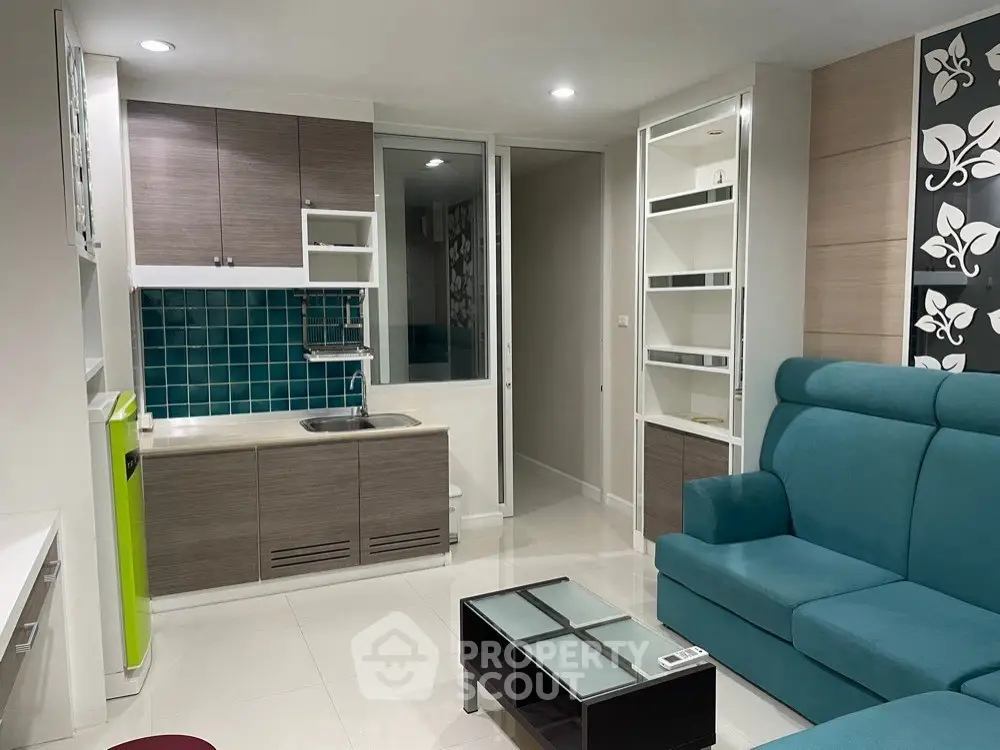 Modern living room with compact kitchen and stylish decor