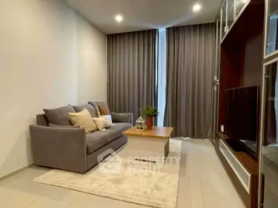 Modern living room with cozy gray sofa, stylish coffee table, and elegant curtains in a chic apartment.