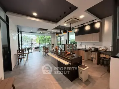 Modern open-layout kitchen with sleek design and ample natural light, perfect for culinary enthusiasts.