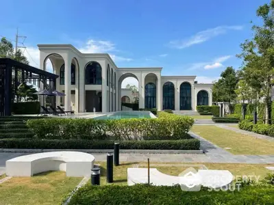 Luxurious modern villa with elegant arches and private pool in lush garden setting.