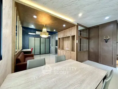 Luxurious dining area with elegant chandelier and modern decor in a spacious apartment.