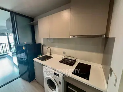 Modern kitchen with sleek appliances and open layout in stylish apartment