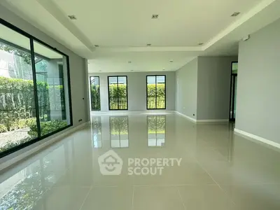 Spacious modern living room with large windows and garden view