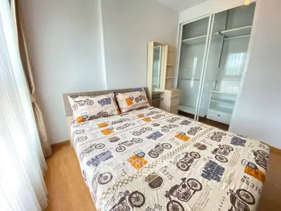 Cozy bedroom with modern decor and ample natural light