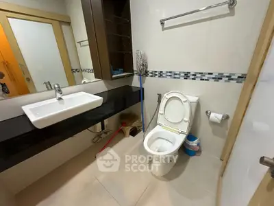Modern bathroom with sleek fixtures and stylish tile accents, featuring a spacious vanity and contemporary design.