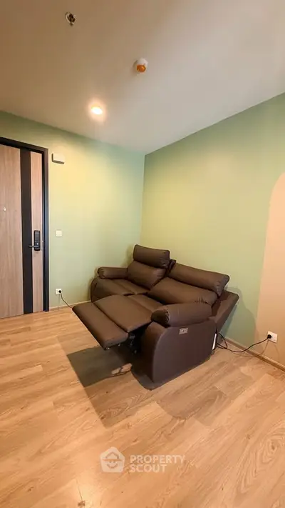 Modern living room with stylish recliner sofa and wooden flooring