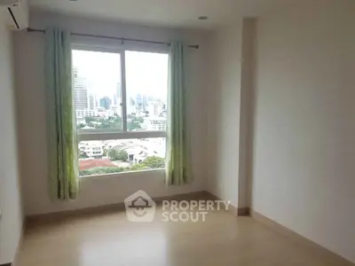 Bright empty room with large window and city view, perfect for customization.