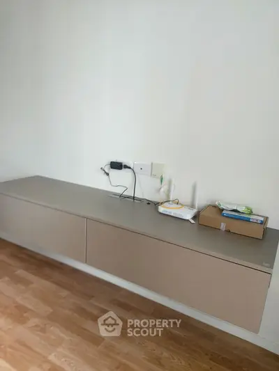 Modern minimalist study area with floating desk and wooden flooring