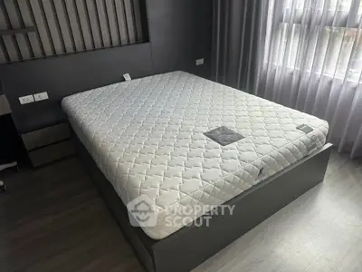 Modern bedroom with stylish bed and large window for natural light