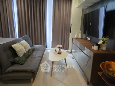 Modern living room with sleek furniture and stylish decor in a cozy apartment setting.