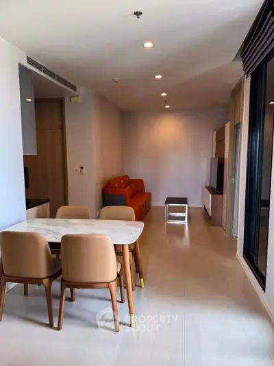 Modern living room with elegant dining area and cozy seating in open layout apartment.