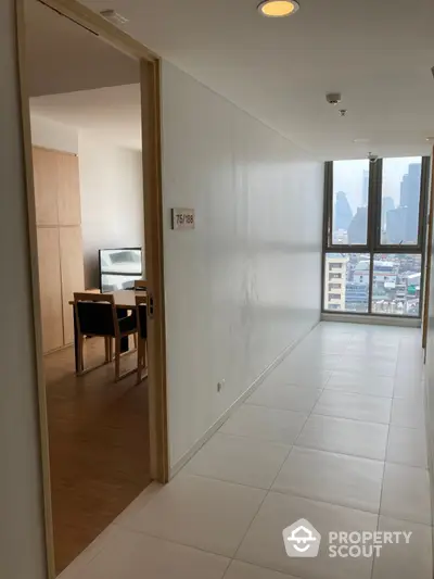 Bright and airy corner unit with expansive city views, featuring a spacious living area with large windows and modern finishes, ideal for urban living.