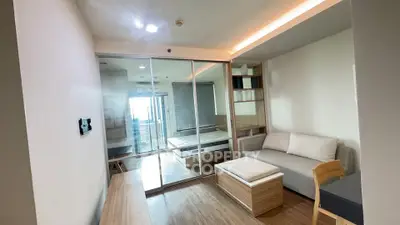 Modern studio apartment with glass partition, cozy living area, and natural light.