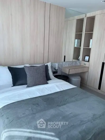 Modern bedroom with stylish wooden cabinetry and cozy bedding