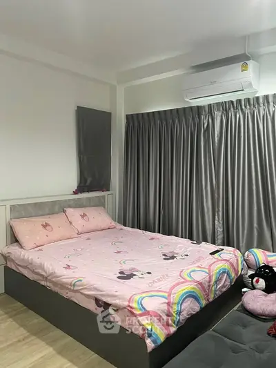 Cozy bedroom with air conditioning and stylish curtains, perfect for restful nights.
