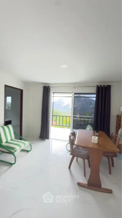 Spacious living room with mountain view and modern furniture